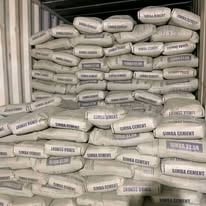 Stacked bags of cement or construction material stored in a warehouse or storage facility