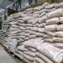 Stacked bags of cement or concrete mix in an industrial warehouse or storage facility